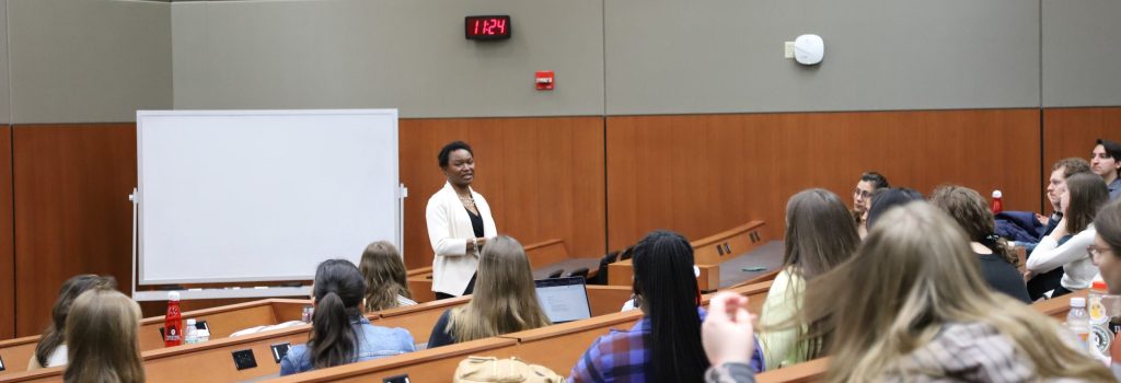 Abiola Keller speaking in a classroom full of students.
